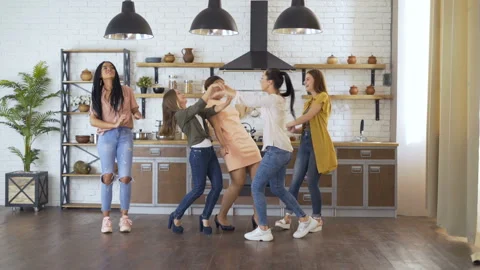5 students friends have fun in the kitchen. girls dance and sing while cooking Stock Footage 114188737