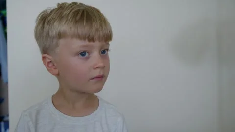 A 5-year-old boy looks out the window Stock Footage 282667047