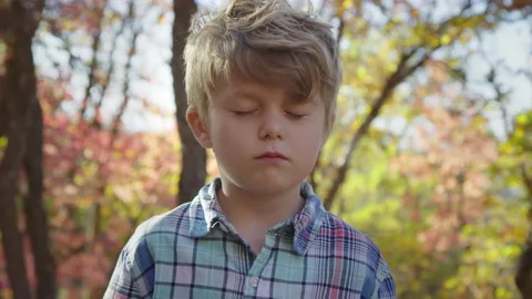 5 year old boy opens eyes to camera with upset expression on face, slow motion 스톡 동영상 194460851