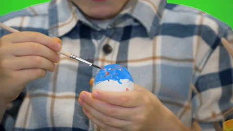 5 year old boy painting Easter eggs, chromakey Stock Footage 170692553