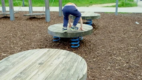 A 5-year-old boy plays on the playground, develops balance 스톡 동영상 243892749