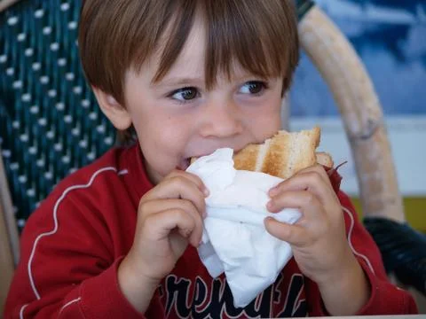 5-year-old child eats a sandwich Stock Photos