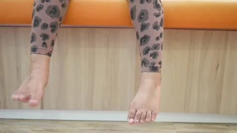 Foto de Two female feet in yoga pants, leggings. Female foot close up do  Stock