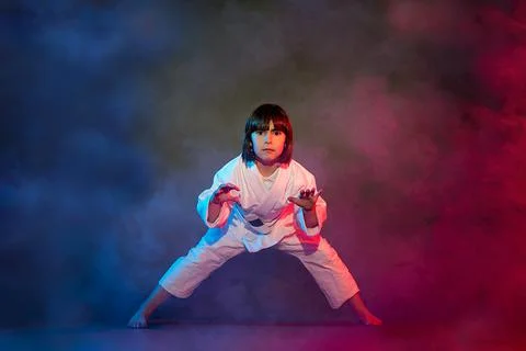 5-year-old elementary school girl, in kimono, practicing martial arts among s Stock Photos