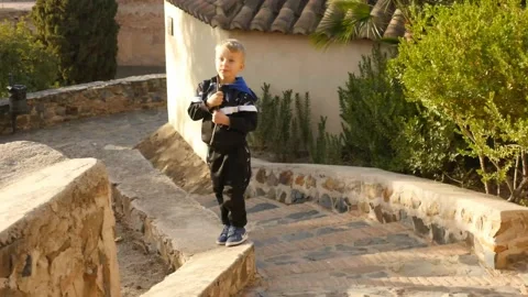 5 years old boy in Gibralfaro fortress lifting with childish games elements Stock Footage 167331553