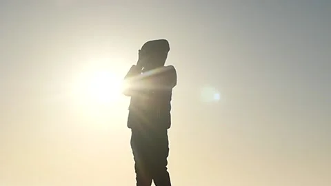 5 years old boy praying silhouette against sun Stock Footage 172431198