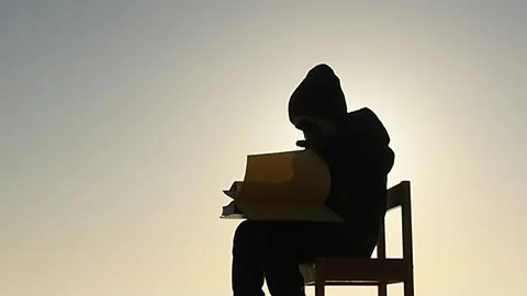5 years old boy read a book , turn the page silhouette Stock Footage 172431230