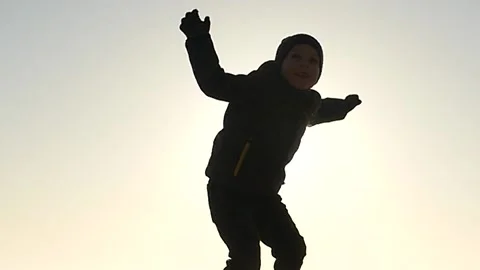 5 years old boy throwing paper plane slow motion silhouette Stock Footage 172431228