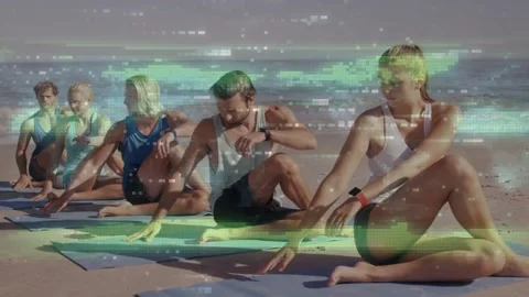 5-yogis following cue doing seated twist for stretch on mats by ocean adjusting Stock Footage 333278511