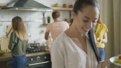 5 young active girlfriends cook a salad and prepare for dinner. put plates on Video stock 114183117