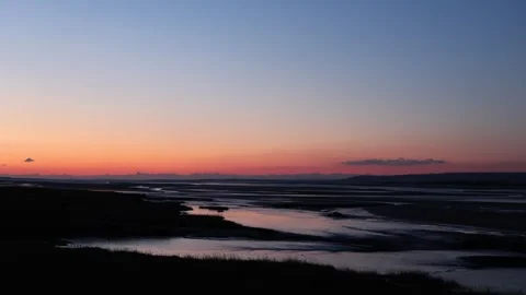 50 frames per second shot of a winter sunset sky over an estuary, with a Video stock 258332480