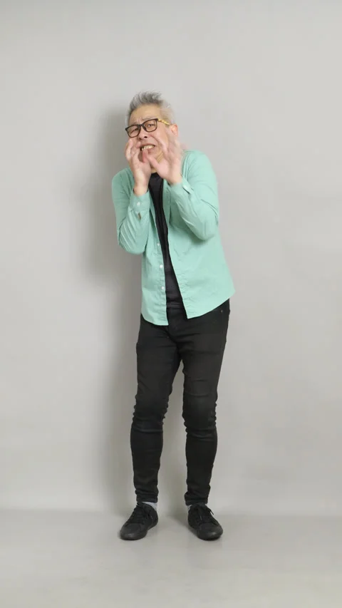 A 50-year-old Chinese man showing signs of horror and panic, covering his mouth  Stock Footage 332845366