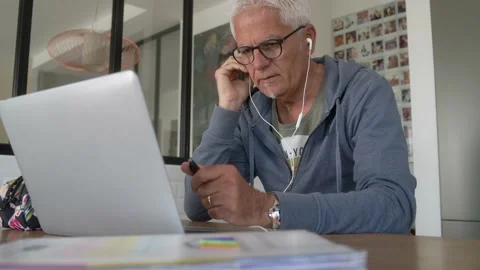 50 year old man working at home on his laptop Stock Footage 151953663