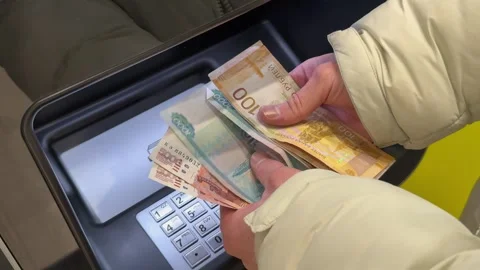 5000, 1000 bills and the hands of a man on the background of an ATM. Stock Footage 322772560