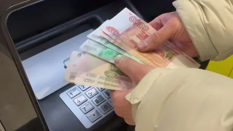 5000, 1000 bills and the hands of a man on the background of an ATM. Stock Footage 322772732