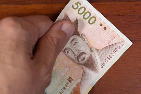 5000 won with hand Stock Photos