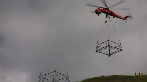 500kV Tower Construction Contruction Air Crane flying in with piece Video stock 48002297