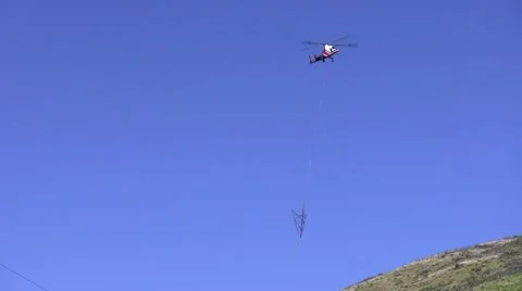 500kV Tower Construction K-Max helicopter with tower leg fly-in Stock Footage 48000594