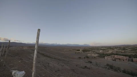 50Fps Panning shot of a small town near sahara desert during sunset Stock Footage 100294577