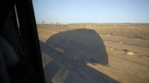 50Fps Shot of shadow of a car while driving through sahara desert Stock Footage 100294217