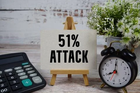 51% Attack text with alarm clock and calculator on wooden background 스톡 사진