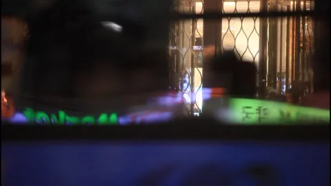 5148 Bus Passing a Department Store with Neon Reflections on the Window Stock Footage 338224700