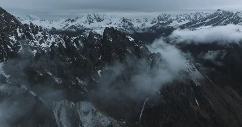 5.1K 50fps Drone: Dark Cinematic Snow Mountain Ridge and Clouds Stock Footage 337103013