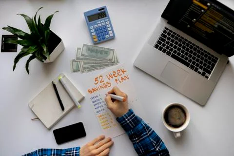 A 52 week saving plan, person count money and calculate the future income Stock Photos