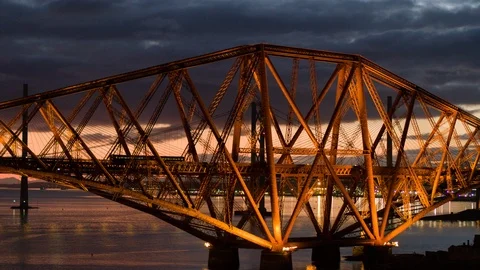 5.2K Aerial train crossing Forth Rail Bridge at night Stock Footage 85737156
