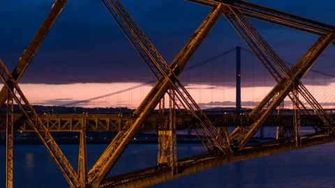 5.2K Aerial train crossing Forth Rail Bridge at night Stock Footage 85757651