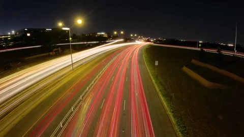 5.3K Backing Plate View - Brilliant nighttime car light trails over expressway Stock Footage 241200600