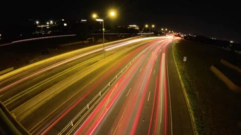 5.3K Backing Plate View - nighttime car light trails over expressway view Stock Footage 241200454