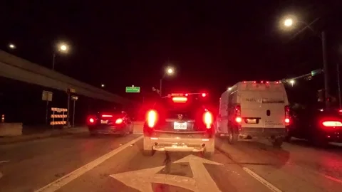 5.3K Driving Plate Front View -Nighttime view stopping passing thru intersection Stock Footage 241201717