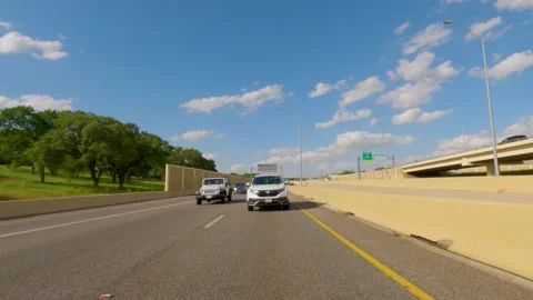 5.3K Driving Plate Rear View - driving down expressway during midday Stock Footage 239342082