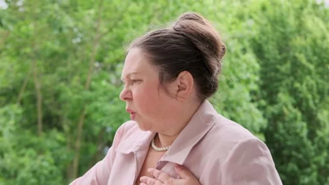 55-year-old overweight woman holds chest... | Stock Video | Pond5