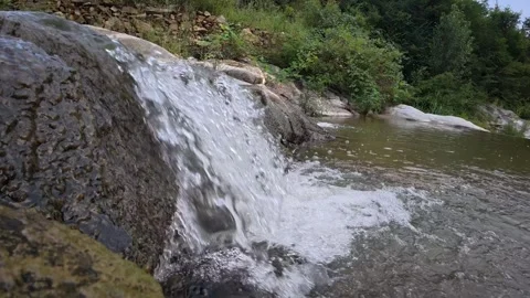 59 Low angle view of clear mountain stream flowing over rocky bed Stock Footage 345459669