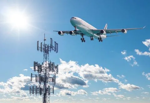 5G Cell phone or mobile service tower with aircraft approaching to land Stock Photos
