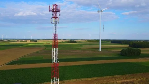 5G Cell Tower Standing Beside Wind Turbine in Rural Agricultural Fields Video stock 342592176
