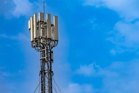 5G Cellular Communication Tower Against Blue Sky  Modern Wireless Network I.. Stock Photos