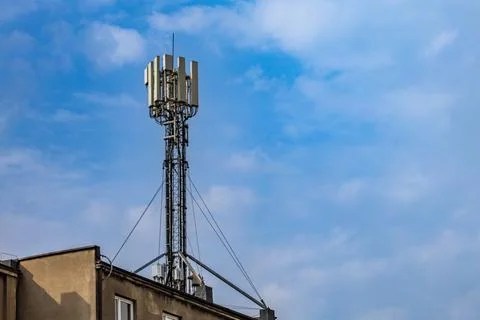 5G Cellular Communication Tower Against Blue Sky  Modern Wireless Network I.. Stock Photos