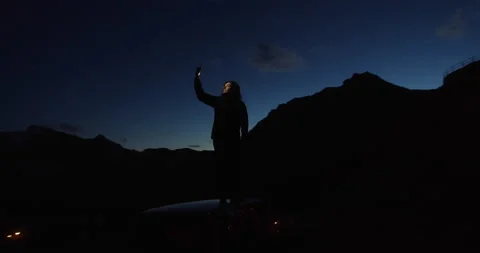 5g data, online communication concept, woman stands on top of a mountain using Stock Footage 142293478