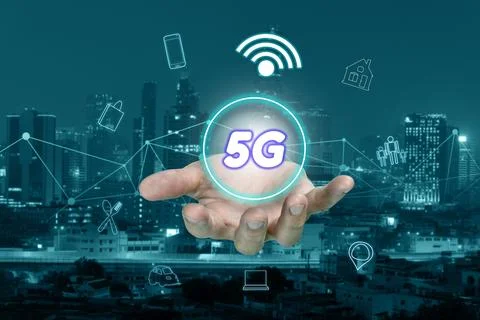 5G network interface on hand and icon concept with cityscape blurred backgrou Stock Photos