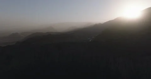 5k Aerial of a Dramatic Hazy Landscape of Backlit Mountain Ridges Stock Footage 321665506