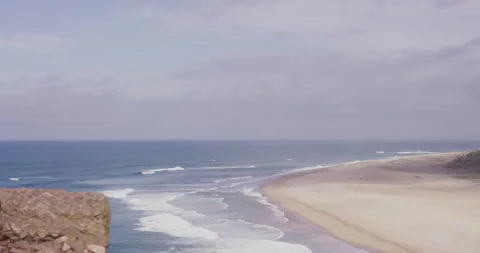 5K of blue ocean with waves splashing on sandy beach during sunny day Stock Footage 158647910