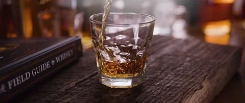 5K - Bourbon poured into a glass Stock Footage 119284530