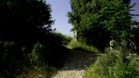 5k HDR Corfu walking on Path next to Tourist with Green Backpack 10Bit Stock Footage 200926646