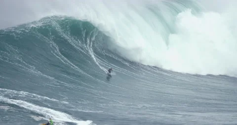 5K of pro surfer surfing down big barrel wave during cloudy day Stock Footage 157714233