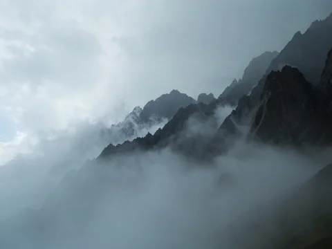 5k Сloud layered mist in mountains timelapse. Sharp and gloomy rocks. Stock Footage