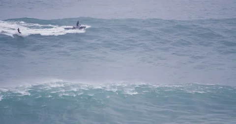 5K Slow motion of pro surfer wakesurfing behind jet ski driver over ocean wave Video stock 157722059