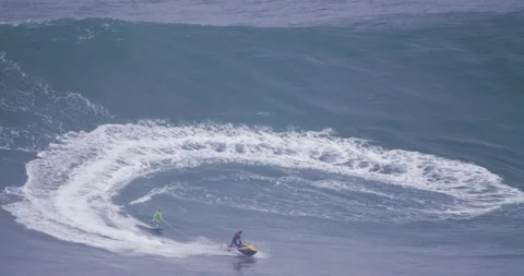 5K Slow motion of pro surfer garrett McNamara wakesurfing behind jet ski driver Video stock 157722390